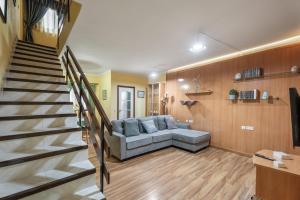 a living room with a couch and a staircase at Casa Francisco in Granadilla de Abona