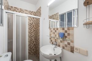 a bathroom with a sink and a toilet and a shower at Casa Francisco in Granadilla de Abona +14 photos