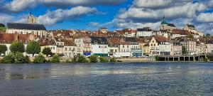 a view of a city with a river and buildings at App de caractère Centre Joigny Z1 in Joigny
