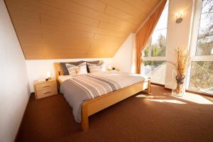 a bedroom with a bed and a large window at Ferienwohnung Mara in Öhningen
