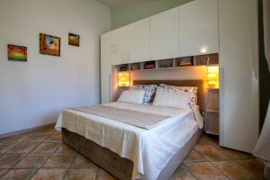 a bedroom with a large bed in a room at Villa Agnese 2- Penthouse- Seaview in Badesi