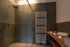 a bathroom with a shower with a glass door at Greiterhof in Lana +46 photos