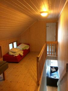 a small room with a bed in a cabin at Sponavik Camping in Stord