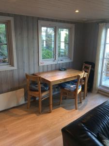 a living room with a wooden table and chairs at Sponavik Camping in Stord