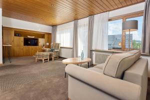 a living room with a couch and a table at Ferienhaus Unmüßig in Hinterzarten