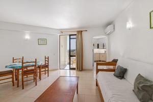 a living room with a couch and a table at Casa Ferrão in Armação de Pêra