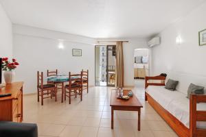 a living room with a couch and a table at Casa Ferrão in Armação de Pêra +13 photos