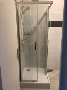 a shower stall with a glass door in a bathroom at Maison David in Nantiat +21 photos