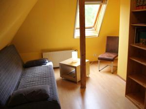 a living room with a couch and a chair at Ferienwohnung an der Müritz in Klink