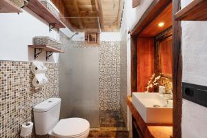 a bathroom with a toilet and a sink at Casa Rural Medina 2 in San Sebastián de la Gomera +17 photos