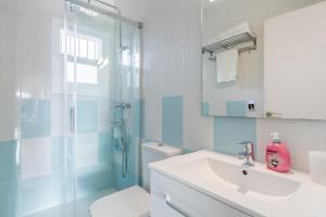 a bathroom with a toilet sink and a shower at Retirosol Bungalow in Denia +14 photos