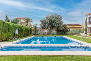 a swimming pool in the yard of a house at Retirosol Bungalow in Denia