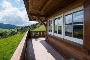 a balcony of a house with a view of the mountains at Riehle Hof in Zell am Harmersbach
