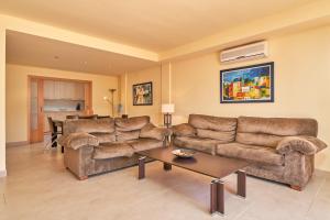 a living room with two couches and a table at Casa Fuentes 2 B2 in Almuñécar