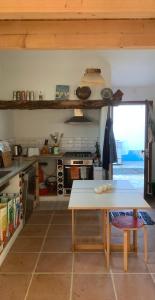 a kitchen with a table and a stove at Sítio Do Valverde in Coruche