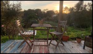 a table and two chairs on a wooden deck at Sítio Do Valverde in Coruche +5 photos