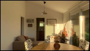 a living room with a wooden table and chairs at Sítio Do Valverde in Coruche