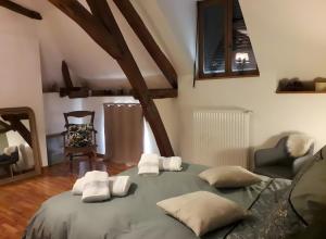 a bedroom with a large bed with four pillows at Chambres d'hôtes Chez Mathilde in Eaux-Puiseaux