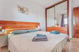 a bedroom with a bed with towels on it at Los Tinajones in La Oliva +22 photos