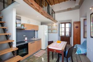 a kitchen with a table and a dining room at Hora Est in Orosei