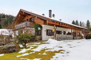 a house with snow in front of it at Chalet Fluh in Oberstaufen