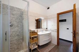 a bathroom with a white sink and a shower at Ai campi in Stella