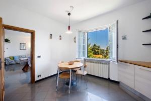 a kitchen with a table and a window at Ai campi in Stella +17 photos