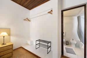 a bathroom with a toilet and a sink at A Cerca - A in Lagos +17 photos