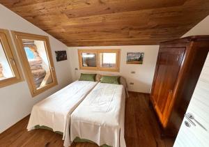 a bedroom with a bed in a small room at Maso 1445,Quiet, Breathtaking Views in Siror