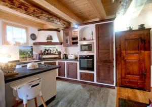 a kitchen with wooden cabinets and a black counter top at Maso 1445,Quiet, Breathtaking Views in Siror