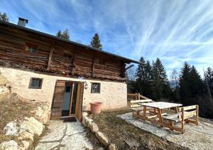 a building with a picnic table in front of it at Maso 1445,Quiet, Breathtaking Views in Siror