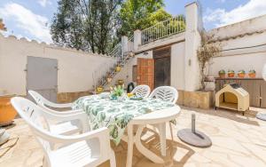 a white table and chairs on a patio at Ca La Rosalia in El Pla de Manlleu