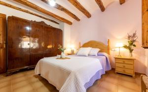 a bedroom with a large bed and a dresser and a bed sidx sidx sidx at Ca La Rosalia in El Pla de Manlleu +19 photos