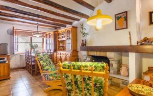 a living room with two chairs and a fireplace at Ca La Rosalia in El Pla de Manlleu
