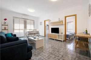 a living room with a couch and a dining room at Casa Relax in Gran Tarajal +14 photos