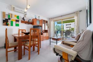 a living room with a table and a dining room at Cambrils park in Cambrils +10 photos