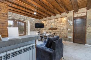 a living room with a television and a table and chairs at Casa Perico in Borrastre