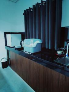 a bathroom counter with a sink and a bath tub at Amelia Villa in Gandara West