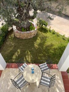 an overhead view of a table and chairs and a tree at Aoni Suites in Egina +48 photos