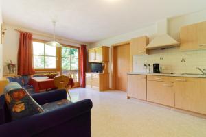 a kitchen and living room with a couch and a table at Leitnerhof in Racines