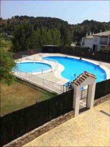 a large blue swimming pool with a fence around it at Villa Viruta in El Bosque