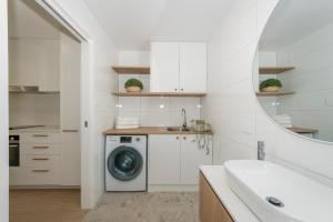 a white kitchen with a washing machine in a bathroom at Marina 14 Harrington in Manning Point
