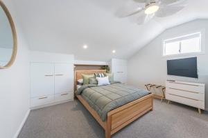 a bedroom with a bed and a flat screen tv at Marina 14 Harrington in Manning Point