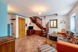 a living room with a couch and a staircase at Casa Montagna in Cadore in San Pietro di Cadore
