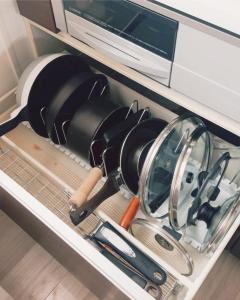 a drawer filled with dishes and a microwave at Chigasaki Southern Beach House 茅ヶ崎サザンビーチハウス in Chigasaki +29 photos