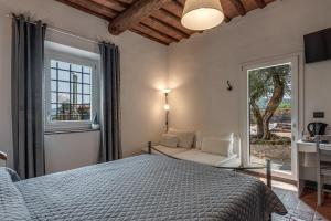 a bedroom with a bed and a window and a couch at Villa Carmela in Lastra a Signa +44 photos