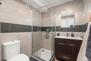 a bathroom with a shower and a toilet and a sink at Sunset Studio in Alvor +21 photos