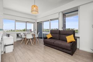 a living room with a couch and a table at Sunset Studio in Alvor