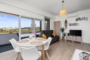 a living room with a table and chairs and a couch at Sunset Studio in Alvor