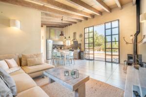 a living room with a couch and a table at Casa Cascada in Costitx